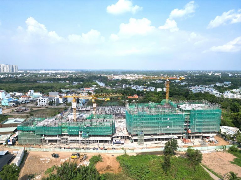 Aerial site photograph of Elysian in April 2025: podium and lower floors under construction with two tower cranes on site
