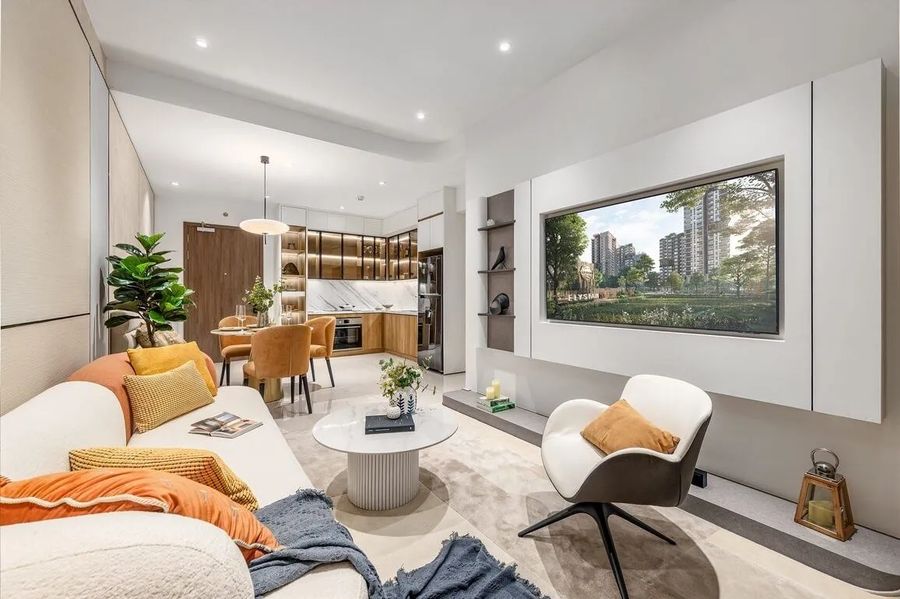 Elysian apartment interior: open living and dining area with the kitchen behind and a wide window onto the garden podium