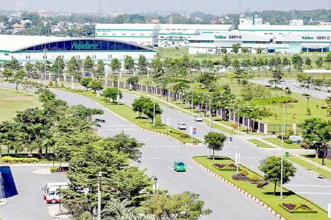 Landscaped boulevard and factory buildings inside Saigon Hi-Tech Park